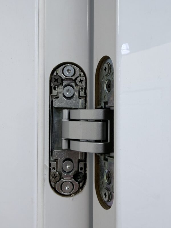 Open interior door showing the concealed hinge mechanism in the door and frame